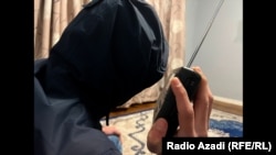 An Afghan listens to Trump inauguration on radio