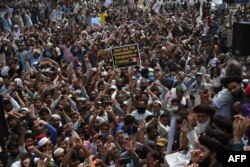 Supporters of Tehrik-e-Labaik Pakistan (TLP) shout slogans during a protest after their leader was detained following his calls for the expulsion of the French ambassador, in Lahore on April 20.