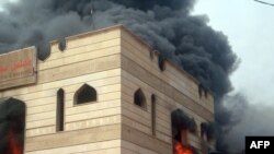 Flames engulf the Wassit provincial council building in the southern city of Kut.