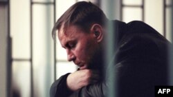 Colonel Yury Budanov sits in the defendant's box during his murder trial in Rostov-na-Donu in April 2003.