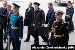 Russian officers carry the nuclear briefcases as President Putin arrives for talks with North Korean leader Kim Jong Un in Vladivostok in April 2019.