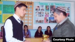 RFE/RL contributor Sazak Durdymuradov (right) in the classroom prior to his late-June detention