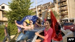 Kosovar Albanians celebrate the court ruling in the divided town of Mitrovica in northern Kosovo.