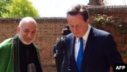 British Prime Minister David Cameron (right) greets Afganistan's President Hamid Karzai oh his arrival at his country residence of Chequers, in Wendover.