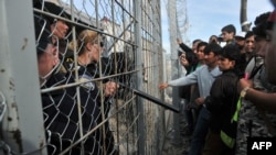 Refugees from Afghanistan protest against the closure of the Greek-Macedonian border earlier this week. A new Amnesty International report has criticized the European Union for failing to come up with "a coherent, humane, and rights-respecting response" to the challenge posed by the migrant crisis. 