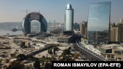 Azerbaijani soldiers carrying a large-scale national flag parade through Baku to mark the anniversary of the end of the 2020 war over the Nagorno-Karabakh region with Armenia on November 8.