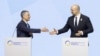 Swiss President Ignazio Cassis (left) and Ukrainian Prime Minister Denys Shmyhal shake hands at the closing plenary of the Ukraine Recovery Conference in Lugano, Switzerland, on July 5.