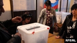 Election commission members count ballots after municipal elections in Baku.