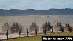 Russian, Chinese, and Mongolian troops and military equipment parade at the end of the day of the Vostok-2018 military drills not far from the Chinese-Mongolian border in Siberia in September 2018.