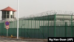 A guard tower and barbed wire fences surround an internment facility in the Kunshan Industrial Park which has previously been revealed by leaked documents to be a forced indoctrination camp in Artux in western China's Xinjiang region. (File photo)