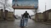 An Afghan migrant who was deported from Germany arrives with his belongings at the international airport in Kabul. (file photo)