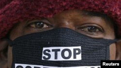 An Indian man takes part in a protest against alleged corruption at a telecom company in New Delhi today.