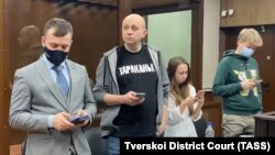 Sergei Smirnov (second from left) at his court hearing in Moscow on February 3. 