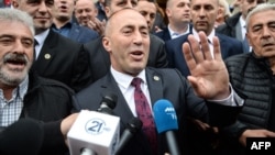 Former Kosovar Prime Minister Ramush Haradinaj (center) speaks to reporters following his release by a French court on April 27. 