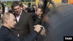 Russian Prime Minister Vladimir Putin signs a section of the pipeline at the Sakhalin-Khabarovsk-Vladivostok transit station in Khabarovsk in July 2009.