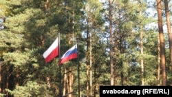 Russian and Polish state flags in fly at the site of the Katyn massacre in Smolensk, Russia.