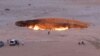 Tourists visit the Gates of Hell, a huge burning gas crater in the heart of the Karakum desert. 