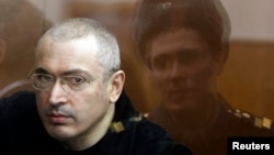 Jailed former oil tycoon Mikhail Khodorkovsky stands in the dock during a court session in Moscow in April 2010.