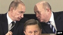 Putin (left) and Mikhail Fradkov chat while Sergei Ivanov gives a speech in 2006.