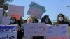 Afghan women hold placards as they take part in a protest in Herat on September 2.