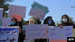 Afghan women hold placards as they take part in a protest in Herat on September 2.