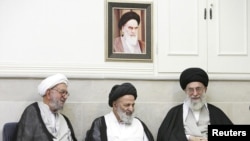 Supreme Leader Ayatollah Ali Khamenei, right, at a meeting with top clerics in the holy Shi'ite city of Qom.