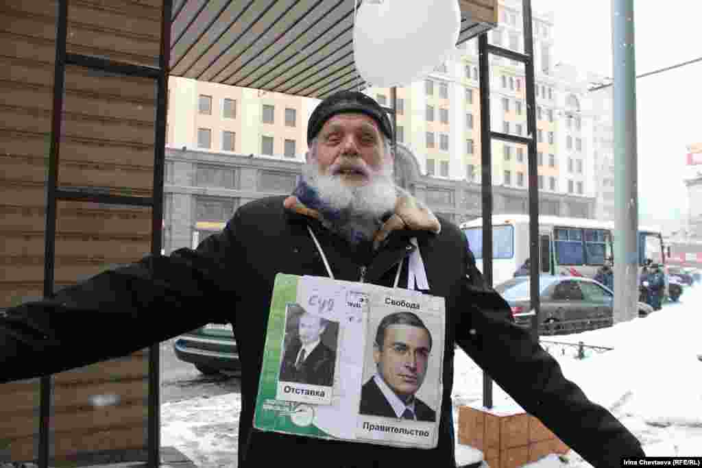 An elderly demonstrator wears a sign with pictures of Prime Minister Vladimir Putin and jailed ex-tycoon Mikhail Khodorkovsky. The former is accompanied by the words &quot;Trial -- Resignation;&quot; the latter reads &quot;Government -- Freedom.&quot; 