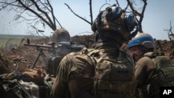 Ukrainian soldiers fire toward Russian positions from a trench on the front line in the Zaporizhzhya region, where Kyiv's forces have made minimal gains and encountered formidable Russian fortifications. (file photo)