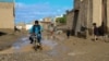 An Afghan motorcyclist drives through a sodden street following heavy rains and flash flooding in the Guzara district of Herat Province earlier this week. 