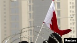 Women walk toward Pearl Square for a demonstration in Manama on February 21.