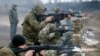 Militants of the self-proclaimed Donetsk People's Republic train at a range in Donetsk.