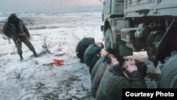 Detainees under Russian guard in Chechnya in a photo by Adam Borowski that is part of a photo exhibition in Prague called "Chechnya: The Final Solution"