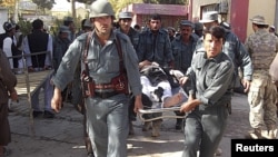 Afghan policemen carry the body of a civilian victim of a bomb blast -- is a continuation of strife and violence the only possible future for Afghanistan.