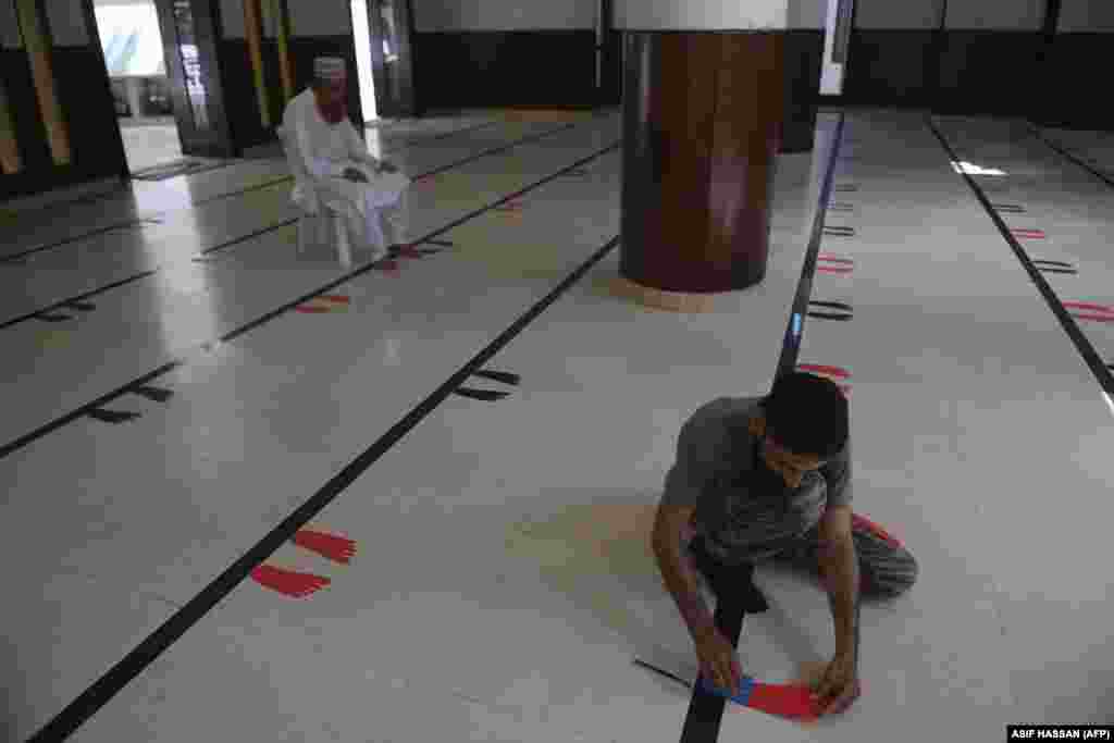 Stickers of foot silhouettes are laid on the floor of a mosque in&nbsp;Karachi, Pakistan, to maintain physical distancing ahead the holy month of Ramadan on April 23.