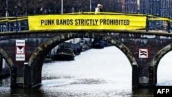 A banner on a bridge in Amsterdam mocks Russian President Vladimir Putin ahead of an April visit with a Pussy Riot allusion.