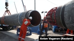 Workers are seen at the construction site of the Nord Stream 2 gas pipeline, near the Russian town of Kingisepp.