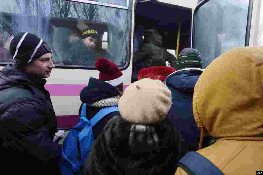 Local residents wait to board a bus to be evacuated from Avdiyivka on February 1.