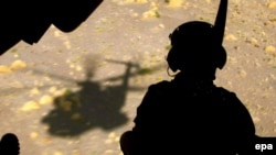 A German soldier sits in the back of a helicopter in Konduz (file photo)