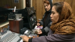 Two Afghan women work in a studio of Voice of Women, the first radio station in Afghanistan to be dedicated to the interests of women, in Kabul in 2005.