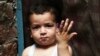 A Pakistani child shows his marked finger after receiving the polio vaccine in Lahore, Pakistan, on April 24.