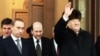 Outgoing Russian President Boris Yeltsin (right) waves as he hands over his office to Vladimir Putin (left) at Kremlin in Moscow on December 31, 1999.