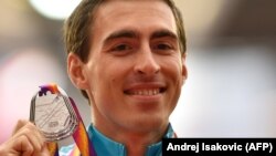 Sergei Shubenkov poses on the podium with the silver medal he won in the 110-meter hurdles event at the 2017 IAAF World Championships in London, where he competed as a neutral athlete. 