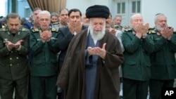 Supreme Leader Ayatollah Ali Khamenei (center) has vowed vengeance for Ismail Haniyeh's assassination in Tehran, which Iran blames on Israel.