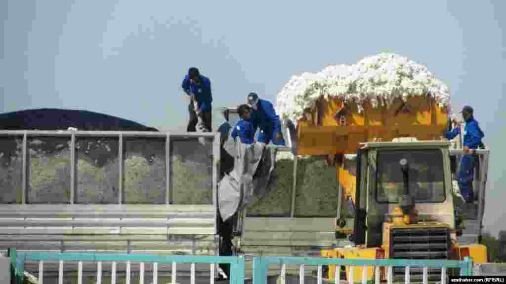 Workers load a cotton harvester in Ahal Province.