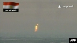 An image grab taken from Egyptian state television shows what the channel said is a flame rising from the site of an attack on a gas pipeline. (AFP Photo/Al-Masriya TV)